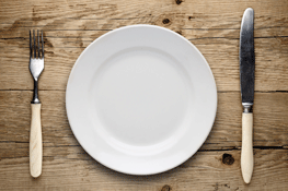Empty Plate, Old Fork and Knife on Wooden Background