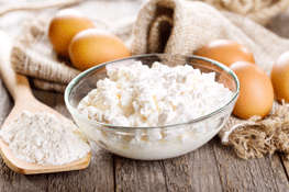 Cottage Cheese, Eggs and Flour on Wooden Table