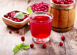 Glass of Cranberry Juice with Fresh Berries on Wooden Table