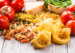 Dried Pasta and Vegetables on Wooden Table